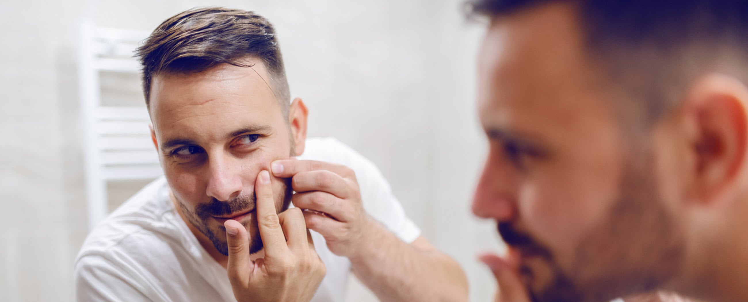 Adult male with mild acne and pimple